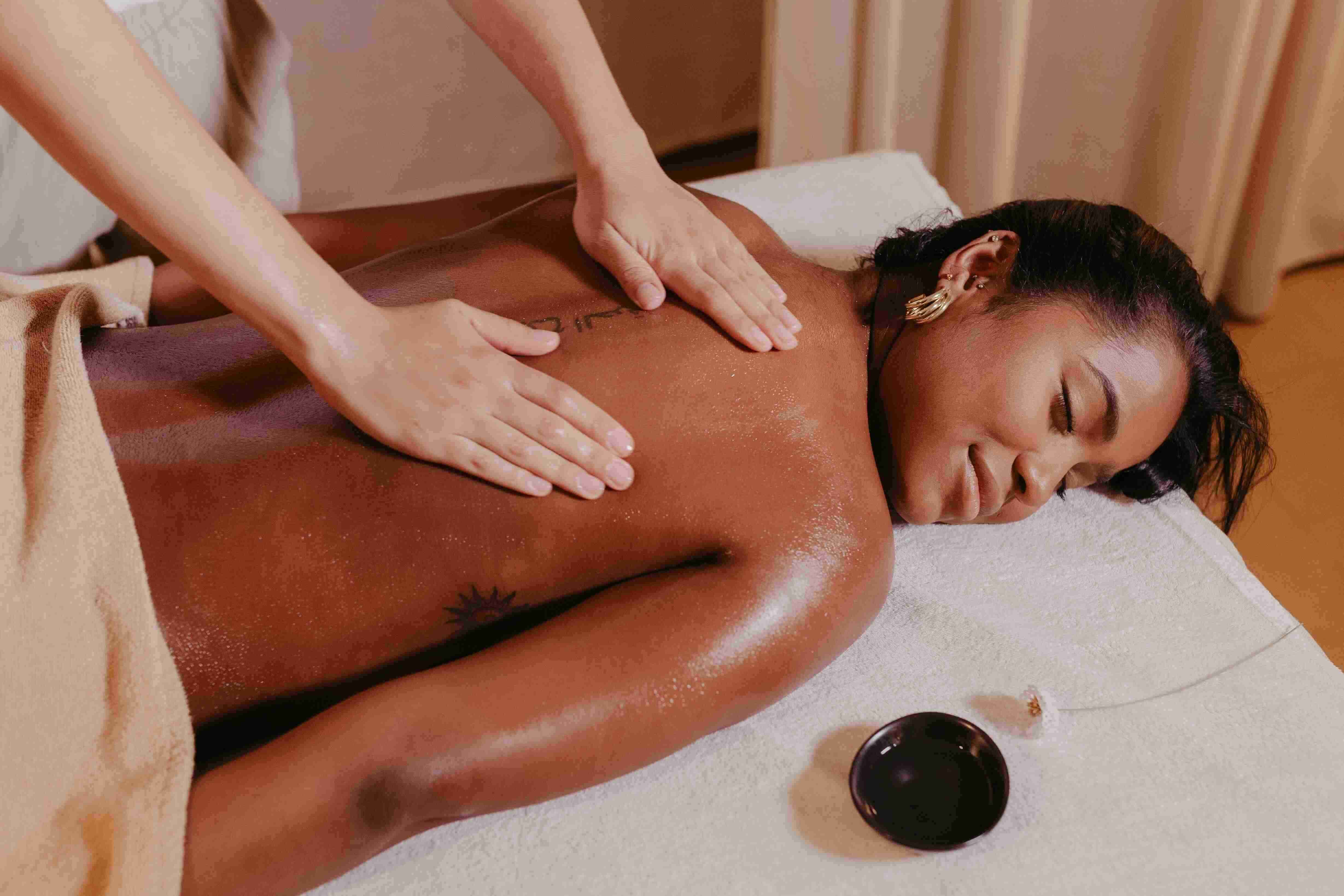 image showing a woman getting a massage using grapeseed oil